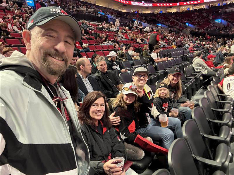 Dr. Collada in the stands at a Portland Trailblazers basketball game with his family.
