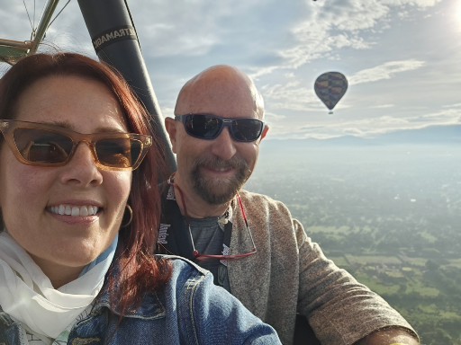 Debra and Dr. Collada on a hot air balloon ride through the clouds.