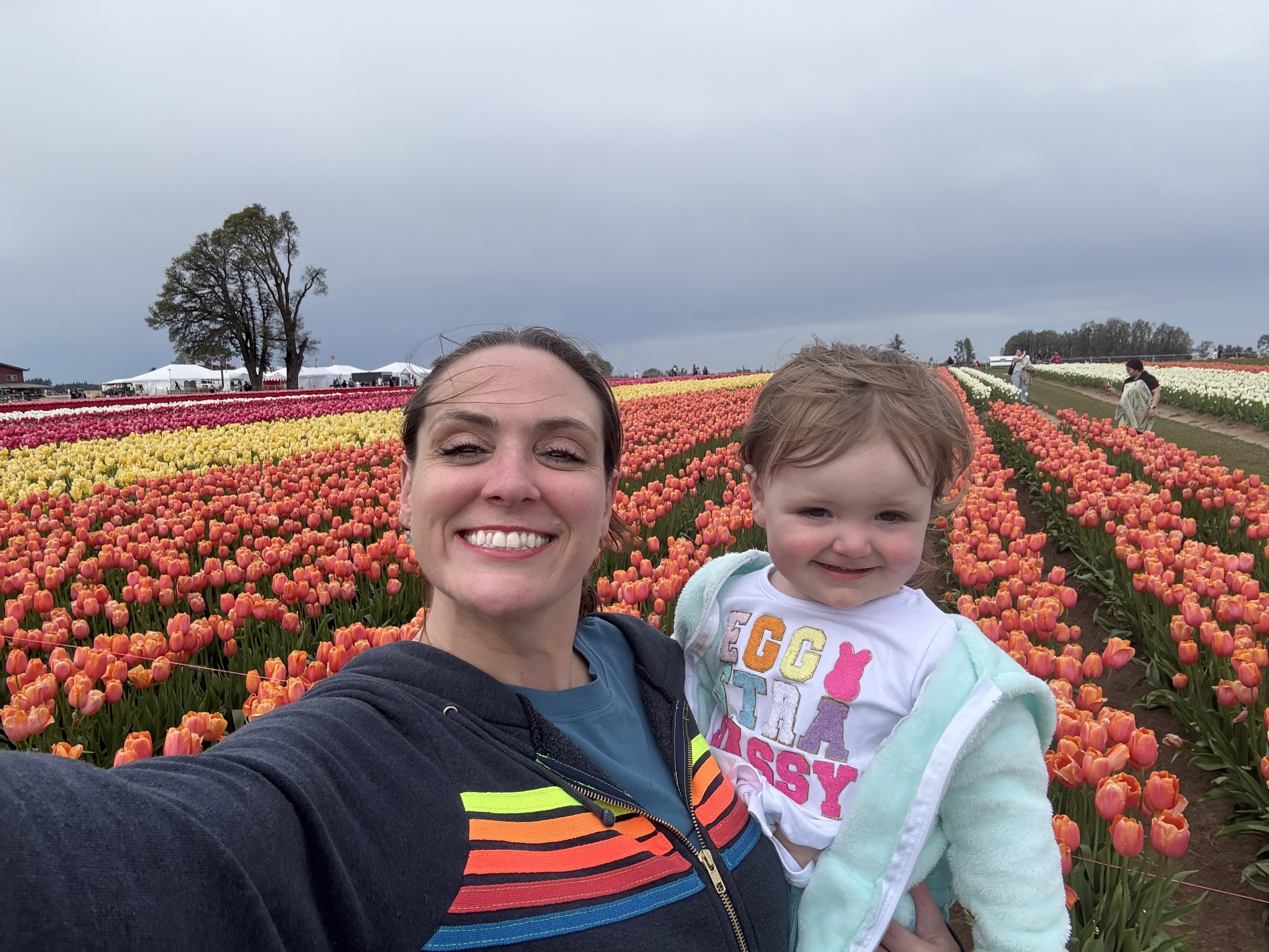 Dr. Meier poses in a tulip field with her toddler.