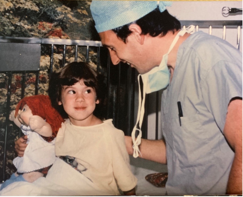 Picture2 Sarah Horn as a child holds a Cabbage Patch Doll as she meets with an anesthesiologist.