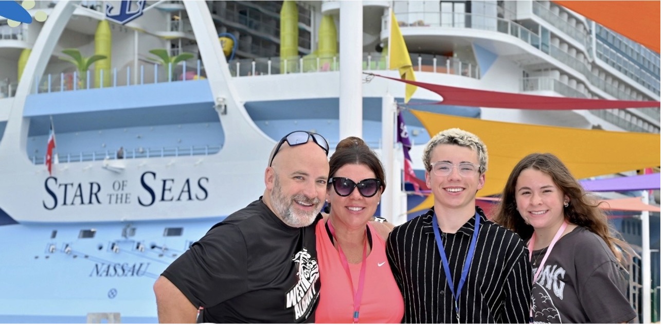 Sarah Horn and her husband and two children in front of their cruise ship.