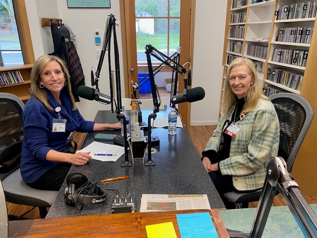 Maggie Hudson and Cheryl Wolfe smiling in the KYAC recording booth