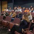 Maggie and Cheryl speaking to a small group in an auditorium at the signing event
