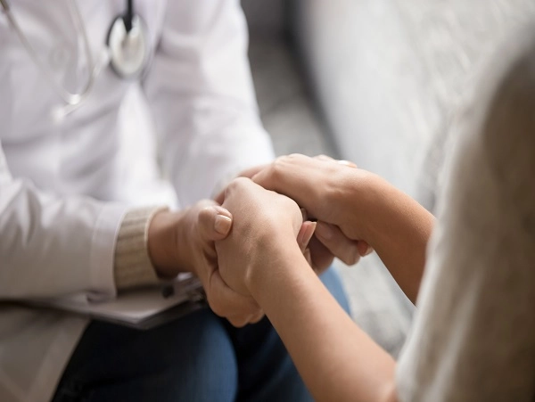 doctor holding woman's hands