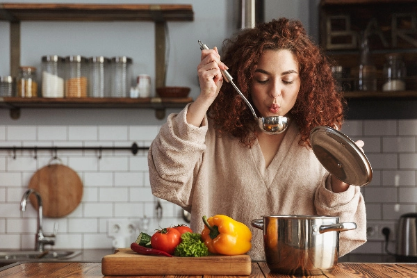 Woman blowing on hot food.