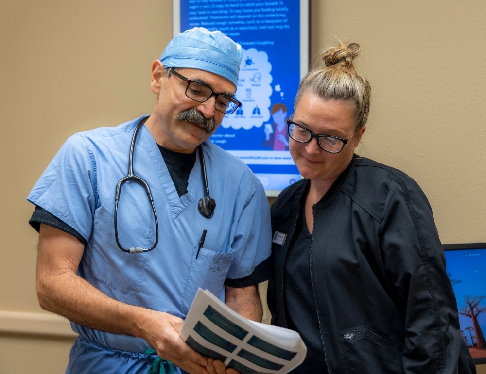 A doctor and nurse reviewing paperwork