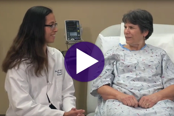 Doctor talking with a patient in a hospital room.