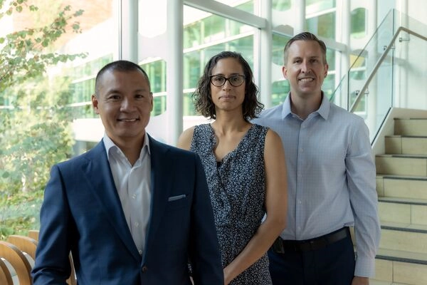 Three cancer doctors standing in the lobby