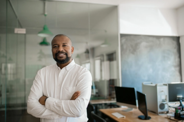 Man standing confidently in an office.