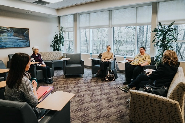 A group of women meet in a CHEC support group room.