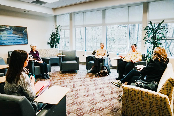A group of women meet in a CHEC support group room.