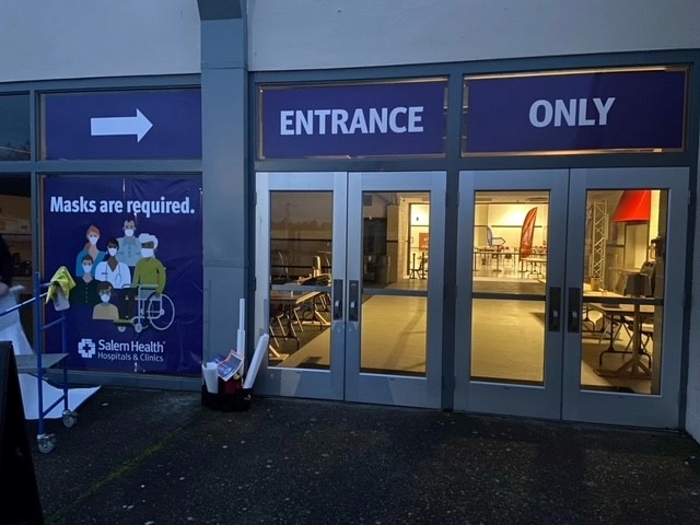 Exterior shot of the doors to the COVID-19 vaccine clinic at the Oregon State Fairgrounds.