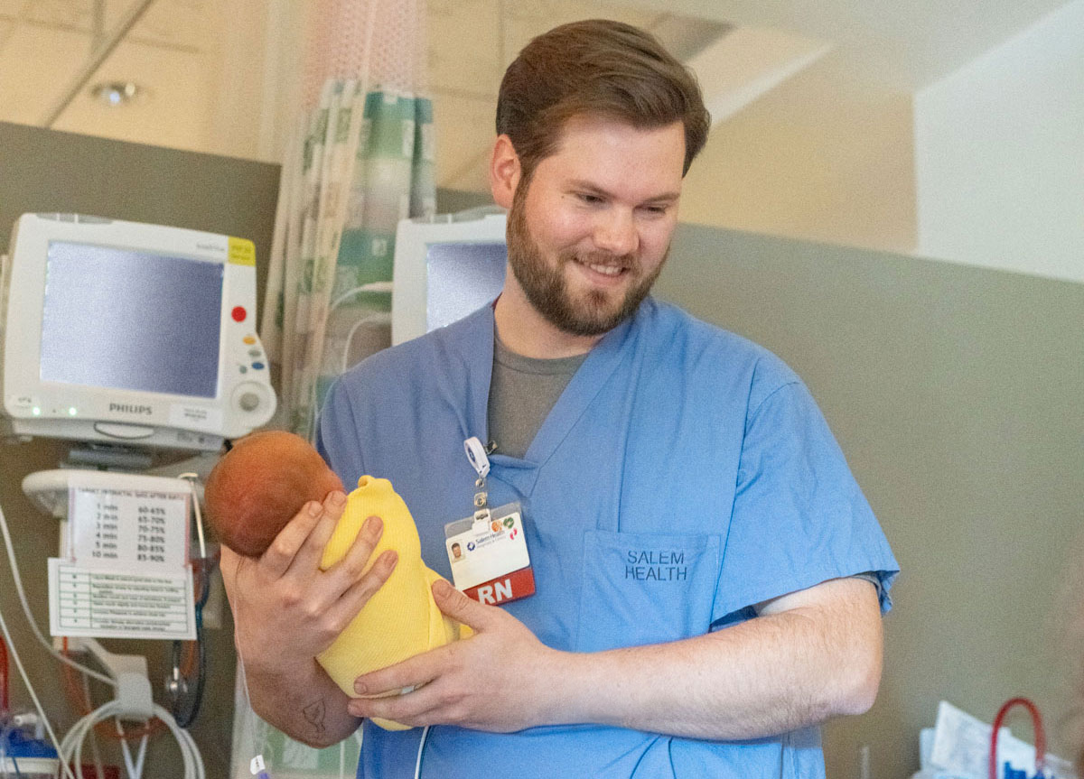 NICU nurse with infant