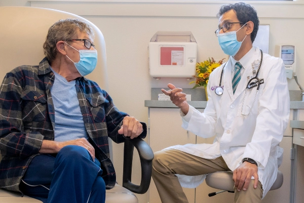 Cardiologist talking with male patient about their treatment plan