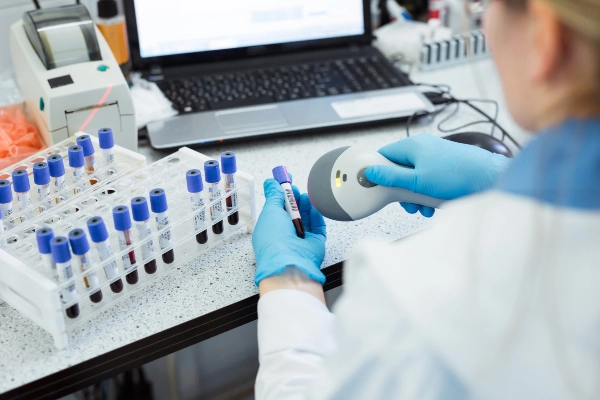 Laboratory worker scanning sample containers