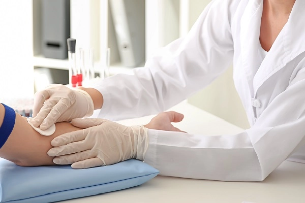 A nurse preps a patient for a blood draw.