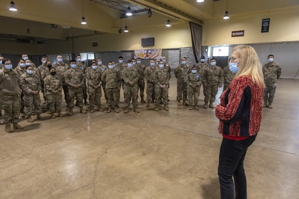 Salem Health CEO Cheryl Wolfe thanks a group of uniformed national guard soldiers for the more than 100 days the troops have served at the vaccine clinic.