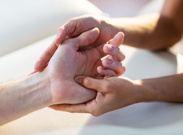 A certified hand therapist works with a patient