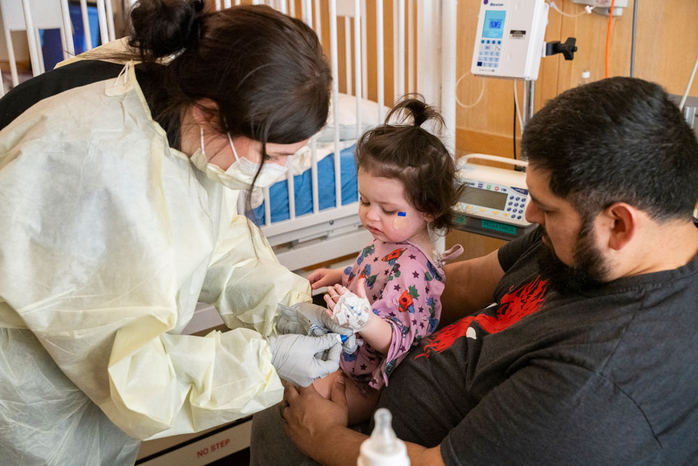 Salem Health nurse helping a young patient