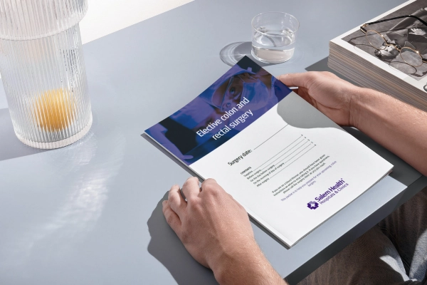 Close up of a person reading the elective colon and rectal surgery packet