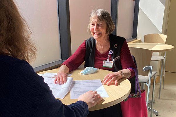Volunteer helps a family member through paperwork.