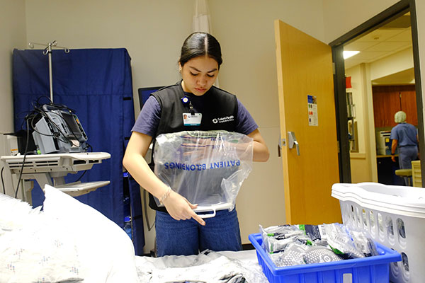 College volunteer helps make take-home bags