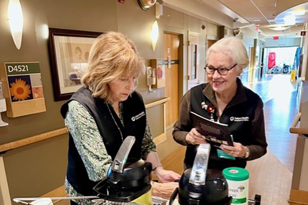 Volunteer helping with hospitality cart