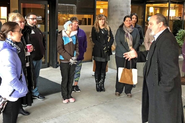 Community Champions tour 2019 cropped Group of hospital staff touring building B