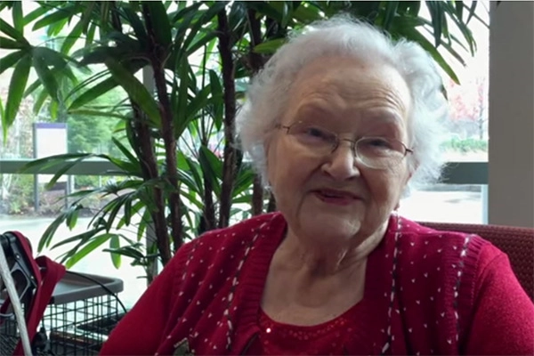 White haired woman with glasses