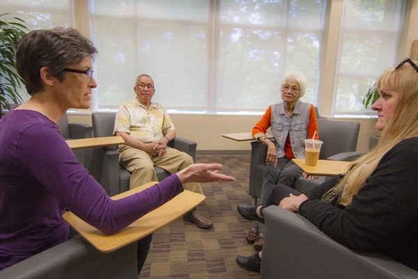 cancer survivors sit in a circle of chairs in Salem Hospital Building D