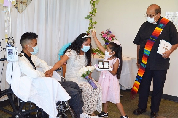 Miguel, Bella and their daughter at their wedding held at Salem Hospital's oncology unit.