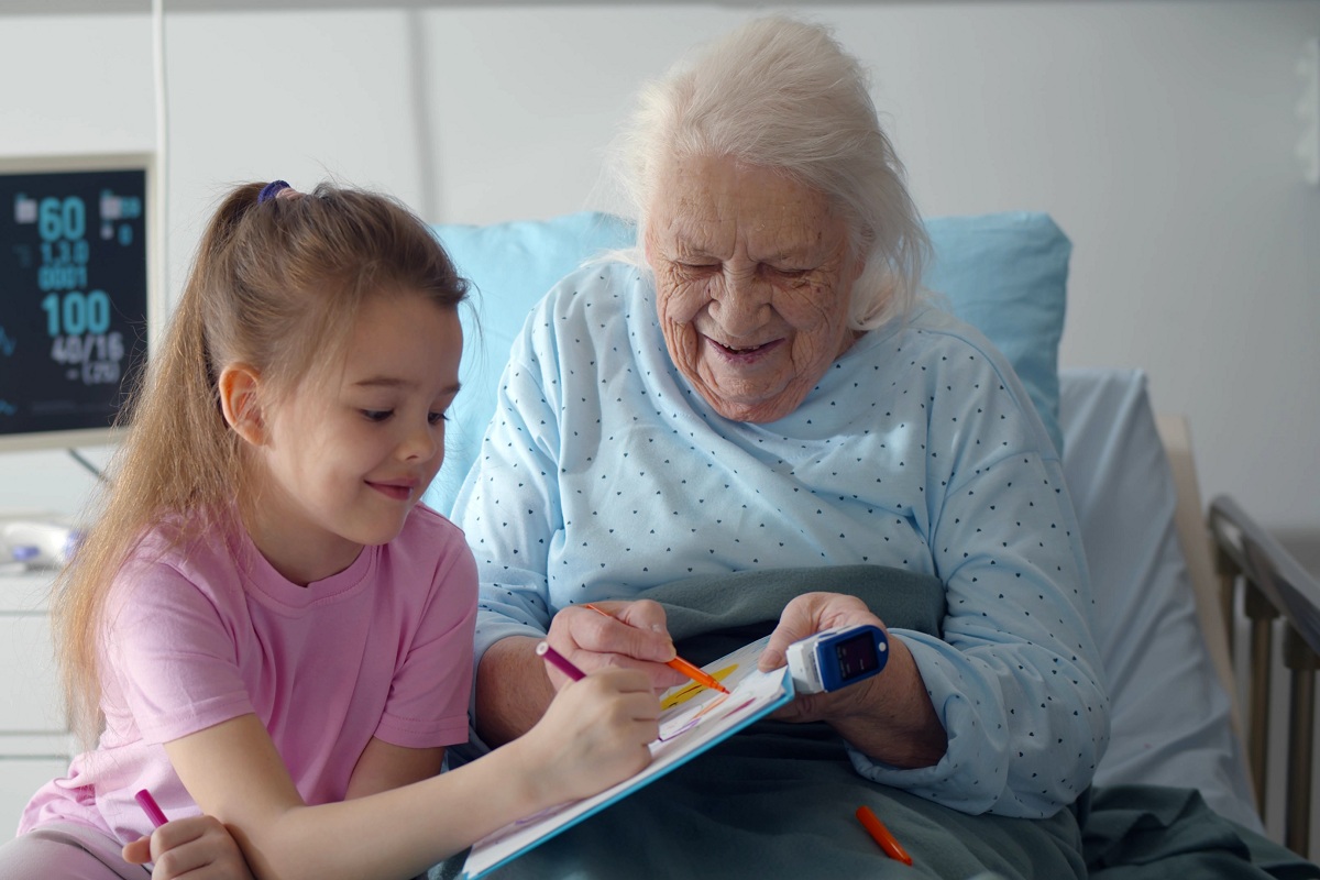 Transitional care swing bed elderly woman visited by granddaughter